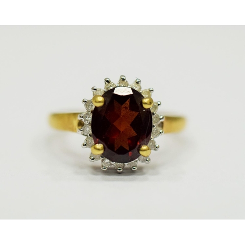 329 - 9ct Yellow Gold Ring set with a Large Central Garnet which measures approx 20 x 12mm and is surround... 