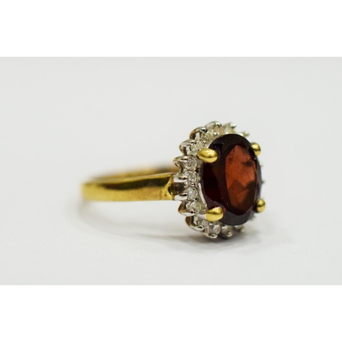 329 - 9ct Yellow Gold Ring set with a Large Central Garnet which measures approx 20 x 12mm and is surround... 