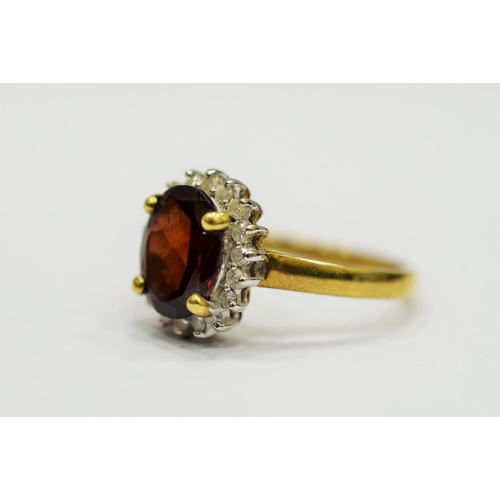 329 - 9ct Yellow Gold Ring set with a Large Central Garnet which measures approx 20 x 12mm and is surround... 