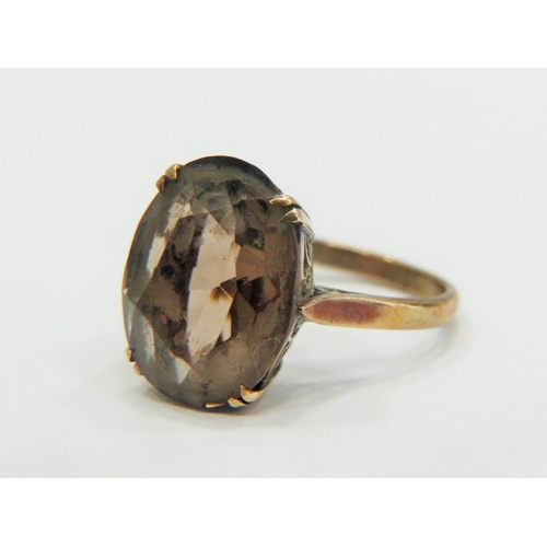 331 - 9ct Yellow Gold ring set with a large Oval Smokey Quartz which measures 15 x 10 mm.  Finger size 'L-... 