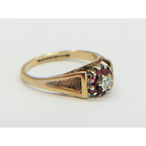 332 - 9ct Yellow Gold Ring set with a small central Diamond, surrounded by small Rubies. Small finger size... 