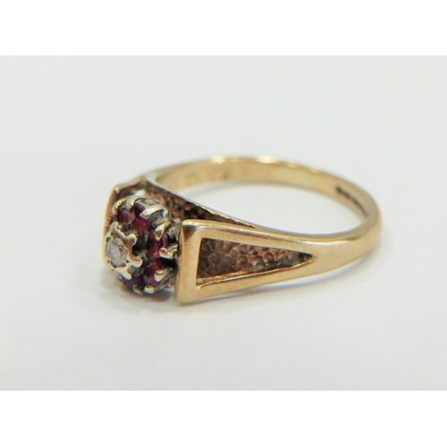 332 - 9ct Yellow Gold Ring set with a small central Diamond, surrounded by small Rubies. Small finger size... 