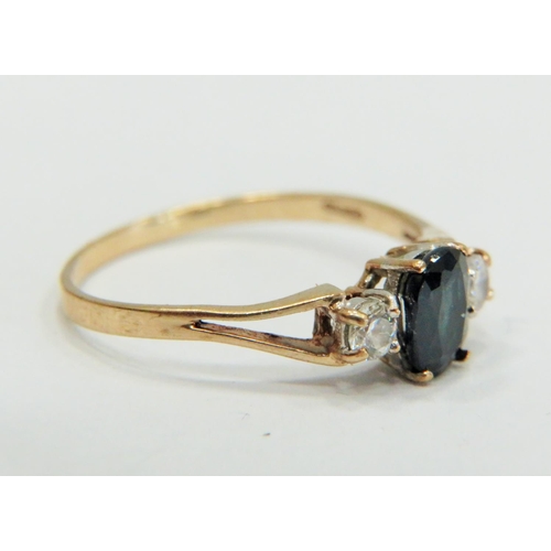 353 - 9ct Gold ring set with a Central Sapphire supported by small CZ gemstones to each side.  Finger size... 