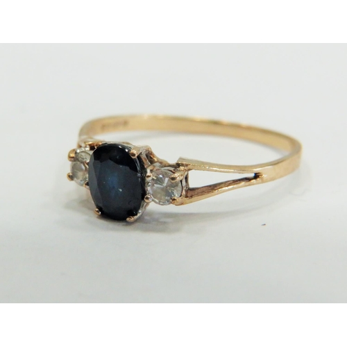 353 - 9ct Gold ring set with a Central Sapphire supported by small CZ gemstones to each side.  Finger size... 