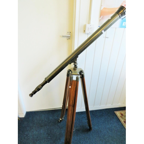 3 - Large metal telescope on a wooden and brass adjustable Tripod mount.

Twist grip zoom, end lens cove... 