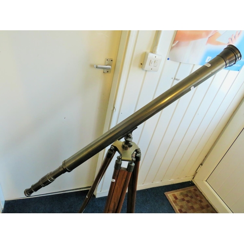 3 - Large metal telescope on a wooden and brass adjustable Tripod mount.

Twist grip zoom, end lens cove... 