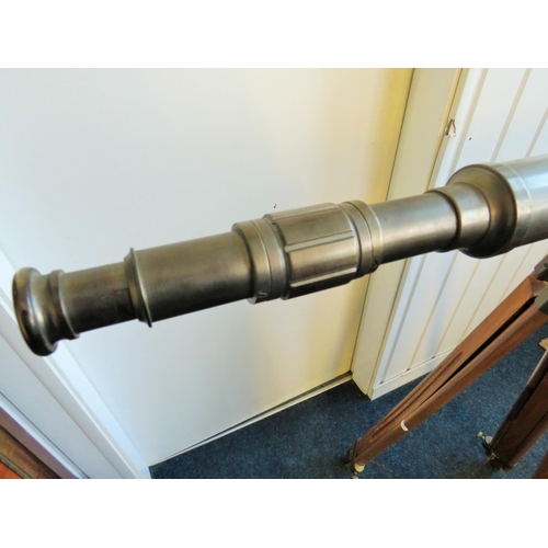 3 - Large metal telescope on a wooden and brass adjustable Tripod mount.

Twist grip zoom, end lens cove... 