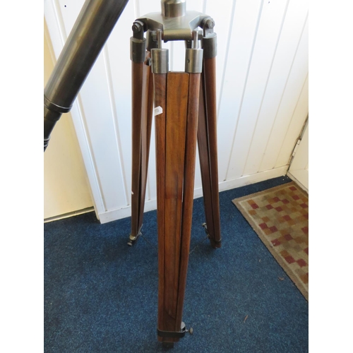 3 - Large metal telescope on a wooden and brass adjustable Tripod mount.

Twist grip zoom, end lens cove... 