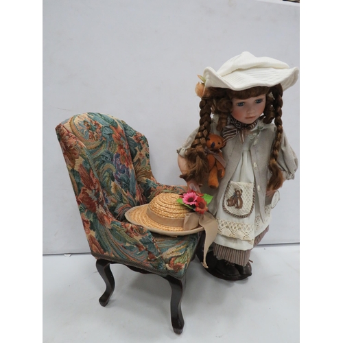 825 - Stuart Ross Porcelain doll and a dolls chair.