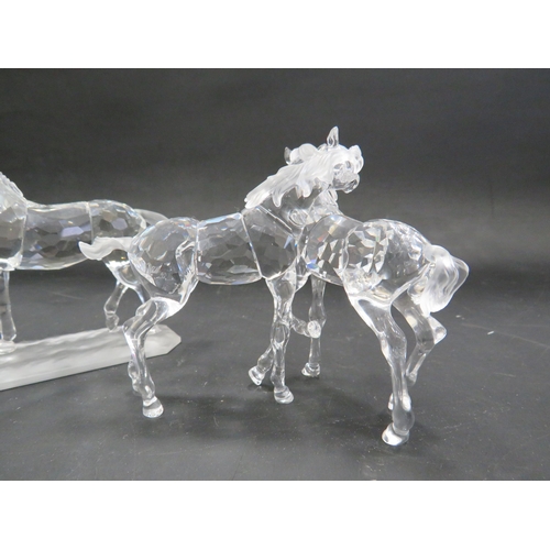 211 - 2 Swarovski crystal horse figurines, Stallion and pair of foals.