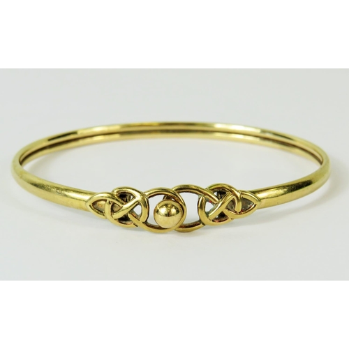 112 - 9ct Yellow Gold Torque bracelet with Celtic knot clasp decoration.  Total Weight 7.6g