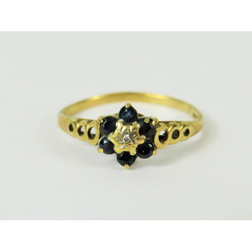 115 - 9ct Yellow Gold ring set with a small central Diamond and surrounded by  six small Sapphires.   Ring... 