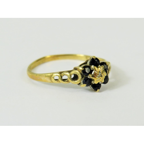 115 - 9ct Yellow Gold ring set with a small central Diamond and surrounded by  six small Sapphires.   Ring... 