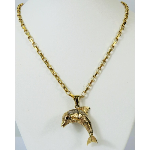 122 - 9ct Yellow Gold Articulated pendant as a leaping Dolphin set with multiple clear gemstones, hung on ... 