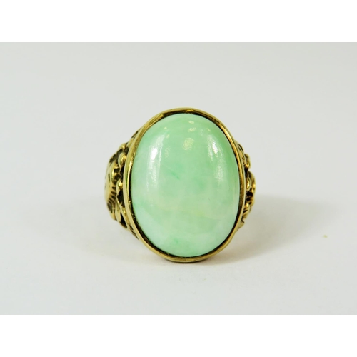 127 - Large Oval Jade ring set in a heavy 9ct Mount with scrolled shoulders.   Finger size 'Q'   Total wei... 