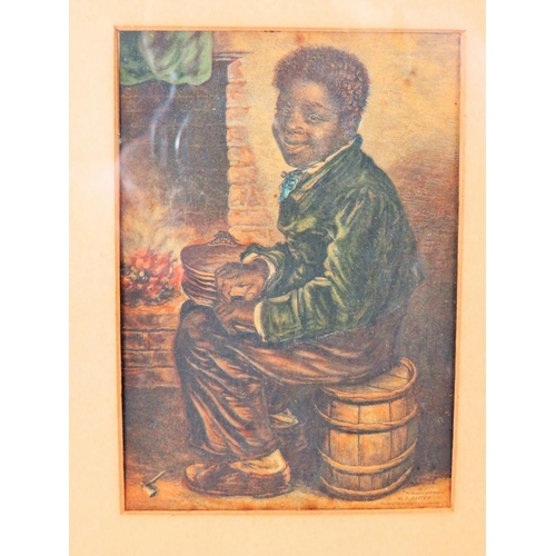 84 - Victorian Lithograph of a small Coloured boy sat by a fire.  Framed and mounted under glass it measu... 