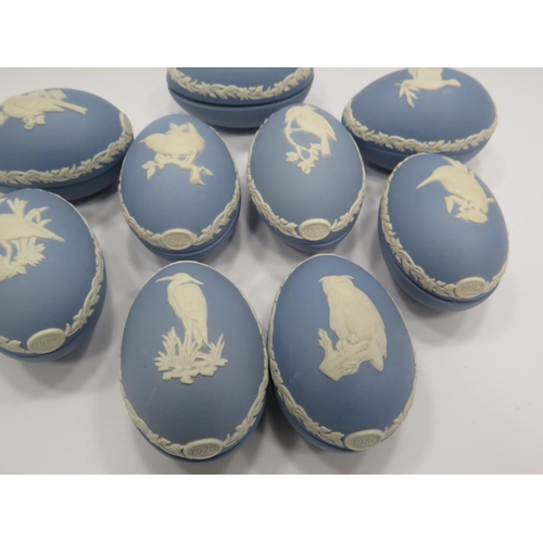 226 - 9 Wedgwood Jasperware light blue christmas eggs decorated with various birds.