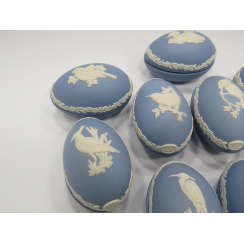 226 - 9 Wedgwood Jasperware light blue christmas eggs decorated with various birds.