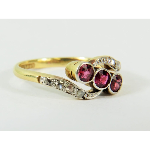 133 - 18ct Yellow Gold Ring set with Three Rubies with Diamond set waves to top and bottom.   Finger size ... 