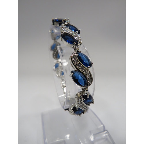 255 - 925 Silver bracelet set with blue and clear gemstones and has a extention piece.