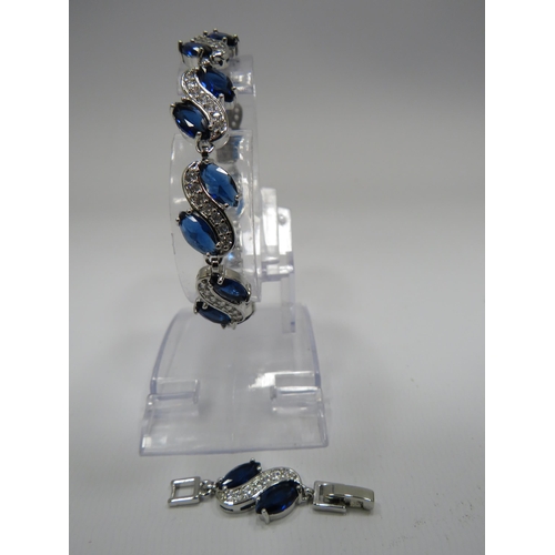 255 - 925 Silver bracelet set with blue and clear gemstones and has a extention piece.