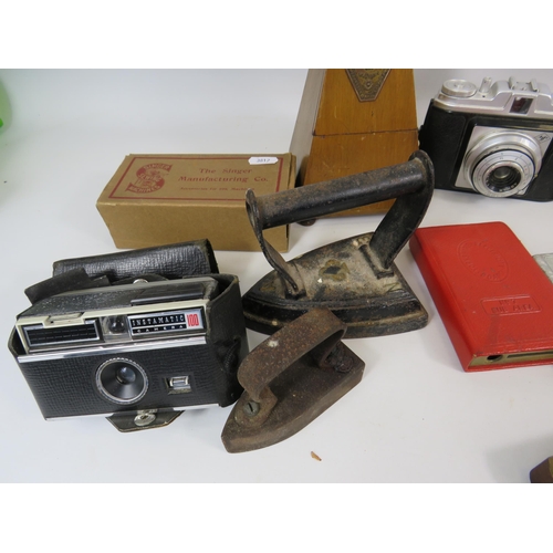 300 - Mixed collectables lot including a metronome, Cameras, cast irons etc.