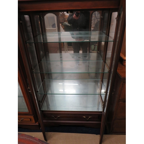 524 - Matched pair of mirror backed glass display cabinets with glass doors. Both illuminated with 240v lI... 