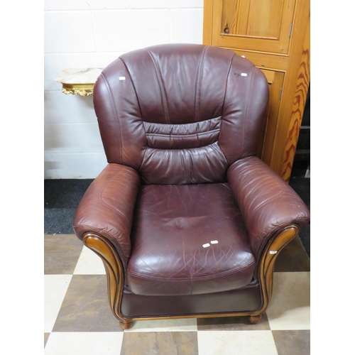 543 - Soft leather armchair with exposed dark wood frame..    See photos.  S2