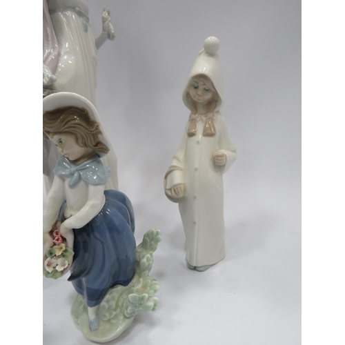 349 - 4 Lladro figures plus one other. The tallest has damage to one hand see pics.