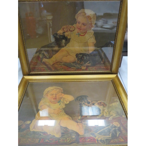 564 - 2 Vintage gilt framed prints of a baby with dogs. 23.5