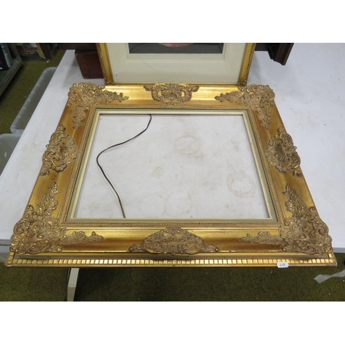 570 - Large gilt rococo style frame 63cm by 72cm plus a signed framed print in a gilt frame.