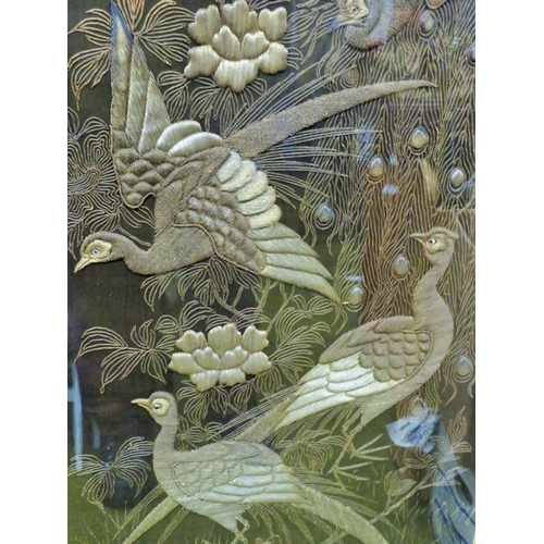 594 - Beautifully embroidered picture of Peacocks, probably Indian made. Framed under hand floated glass i... 