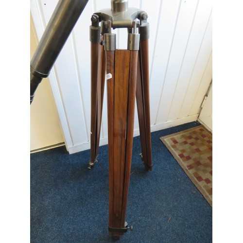 576 - Large metal telescope on a wooden and brass adjustable Tripod mount.

Twist grip zoom, end lens cove... 