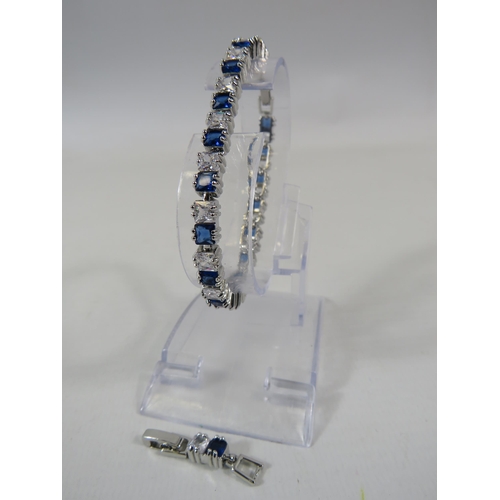 165 - 925 silver blue and clear gemstone tennis bracelet with extension link.