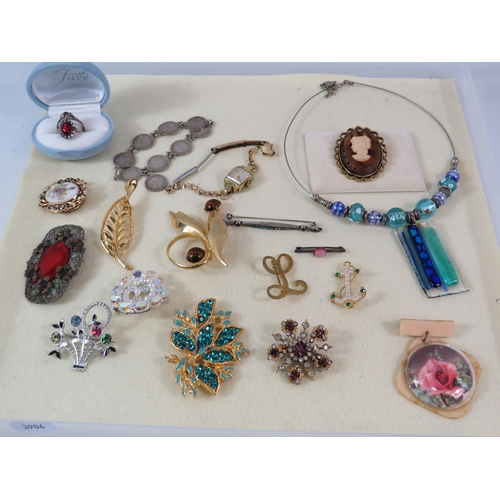 169 - Selection of various vintage costume jewellery including a sterling silver coin bracelet and a rolle... 