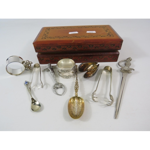 177 - Wooden box and contents including a pair of art nouveau pincers, napkin rings etc.