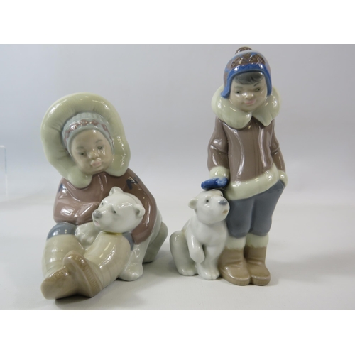 23 - 2 Lladro figurines of Eskimo boys with Polar bears. The tallest measures 15cm.