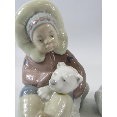 23 - 2 Lladro figurines of Eskimo boys with Polar bears. The tallest measures 15cm.