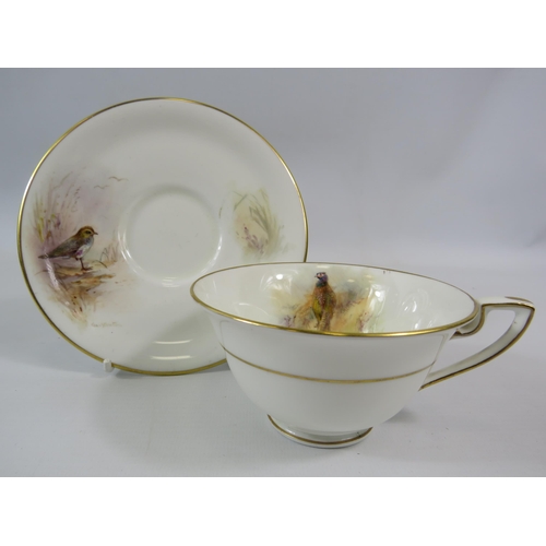 9 - 1949 Royal Worcester J Stinton cup and saucer, the cup painted with a pheasant and the saucer a Plov... 