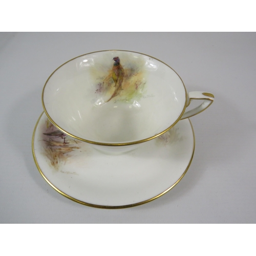 9 - 1949 Royal Worcester J Stinton cup and saucer, the cup painted with a pheasant and the saucer a Plov... 