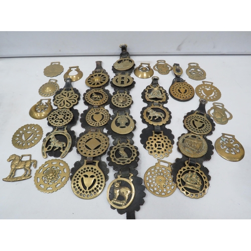 841 - 35 vintage horse brasses some with leathers.