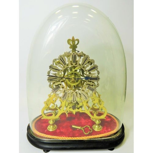 36 - Brass Skeleton clock with wooden base and glass dome cover. No makers mark visable. Comes with key a... 