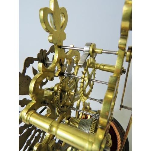 36 - Brass Skeleton clock with wooden base and glass dome cover. No makers mark visable. Comes with key a... 