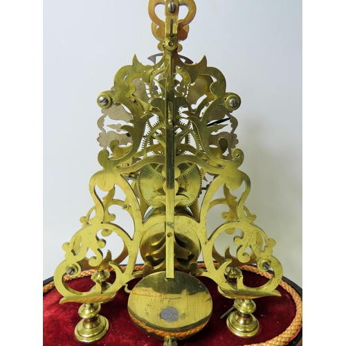 36 - Brass Skeleton clock with wooden base and glass dome cover. No makers mark visable. Comes with key a... 