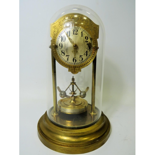 39 - Brass based Anniversary clock under perspex Dome.  Appears to be in running order but no key present... 