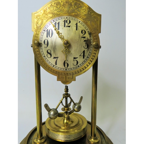 39 - Brass based Anniversary clock under perspex Dome.  Appears to be in running order but no key present... 