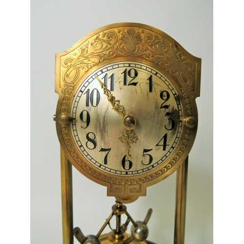 39 - Brass based Anniversary clock under perspex Dome.  Appears to be in running order but no key present... 