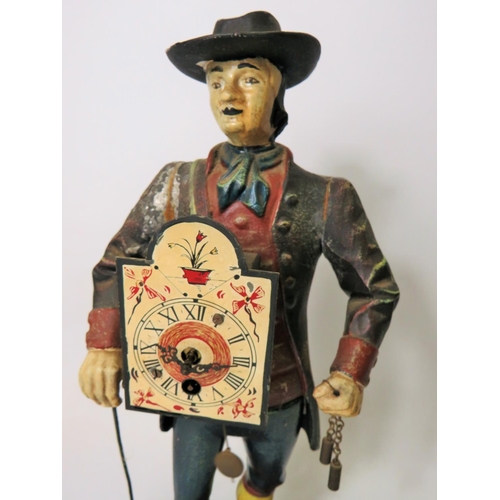 42 - Early 20th Century Cast Iron figural novelty Clock as a Clock Peddler. Painted cast Iron body in goo... 