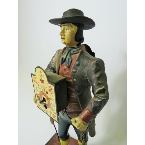 42 - Early 20th Century Cast Iron figural novelty Clock as a Clock Peddler. Painted cast Iron body in goo... 