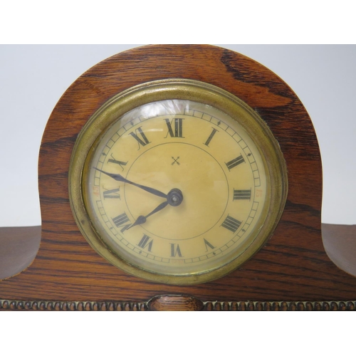 43 - Oak cased mantle clock with ornate carving to the base. Brass mechanism in running order. Measures 1... 